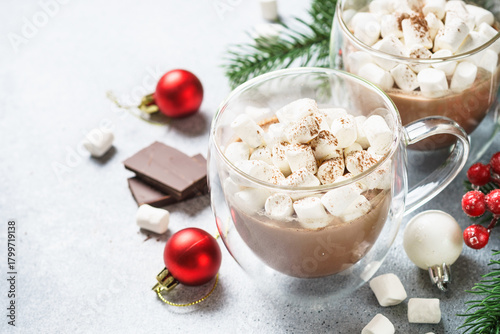 Christmas hot chocolate or cocoa with marshmallow on white with christmas decorations.