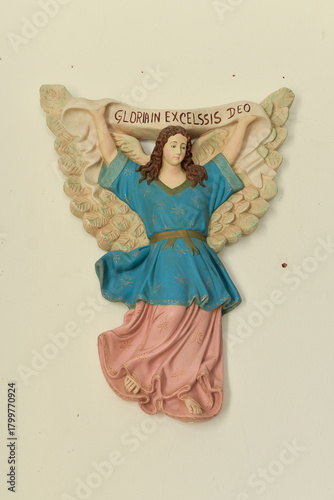 religious decoration, Religious wall carving of an angel holding a banner inscribed 