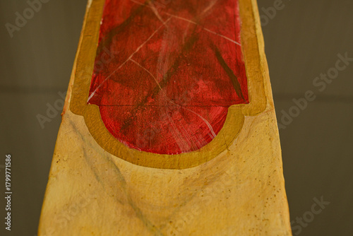 abstract close up of red and gold painted surface with textured details, artistic handcrafted object showing color contrast and organic shapes, creative composition with shallow depth of field horizon