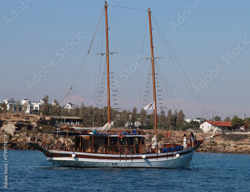 Traditional sailing boat cruising cyprus coastline