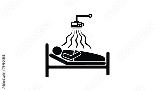 Sick person in bed receiving medical treatment from overhead device