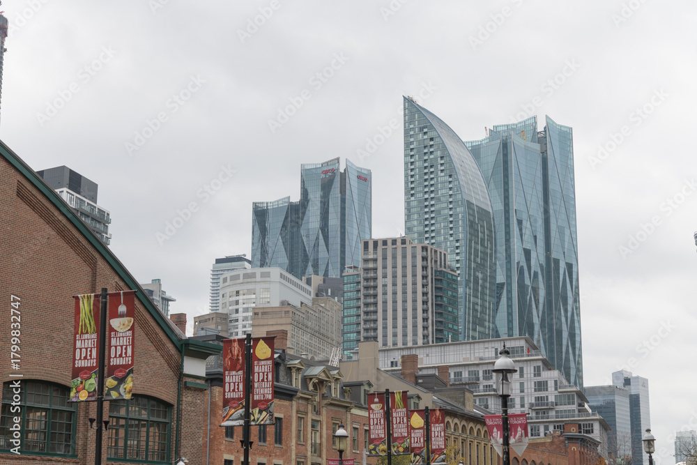 Fototapeta premium looking southwest on Front St E to historic buildings and recent architecture incl L-Tower and CIBC Square, from St Lawrence Market area, Toronto