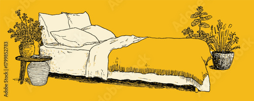 A bed with a yellow comforter and two pillows. A potted plant is on the bed