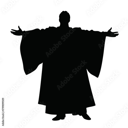 Silhouette of a man wearing traditional robe with arms outstretched  