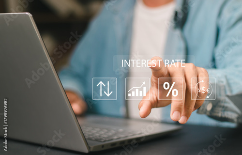 Interest rate financial and mortgage rates concept. Businessman touching interest rates icon on virtual screen. Calculate variable interest rates according to benchmarks.