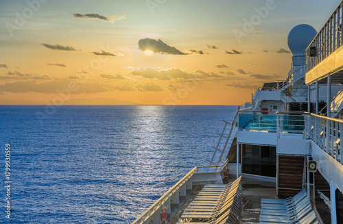 Sea horizon at sunrise from deck of cruise ship: in the distance the coast of the Calabria region, southern Italy.