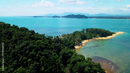 Aerial view of Pantai Bukit Keluang, Besut, Terengganu, showing turquoise waters, coastal cliffs, and clear sunny skies along the scenic shoreline.