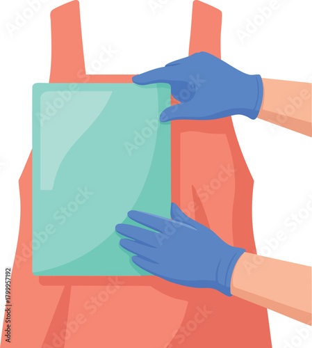 Gloved hands carefully placing a protective chest plate onto an apron for safety or lab preparation