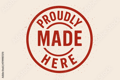 Round seal PROUDLY MADE HERE condensed ink splatter texture red hue vector emblem