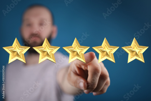 A man points at five golden...