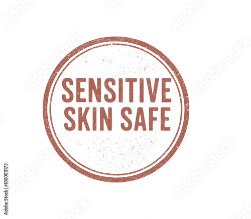 Circular badge SENSITIVE SKIN SAFE uppercase condensed font faded red ink pressure rustic ink texture