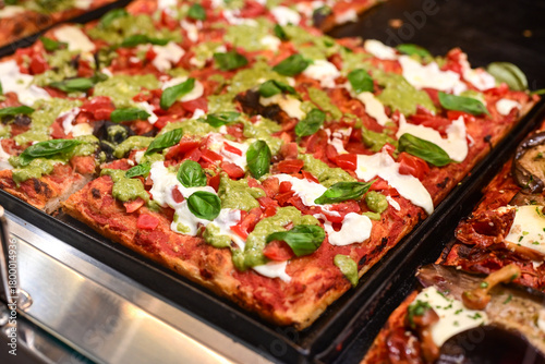 Authentic Italian pizza in a restaurant display window in Rome, Italy.  Different type of traditional Roman styple pizza . 