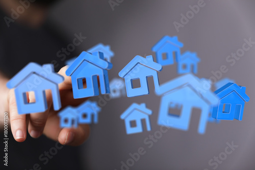 Hand holding blue houses fl...