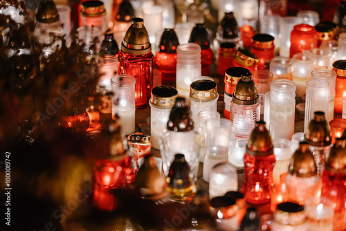 Billede på lærred Glowing Memorial Candles in Red and White Creating a Peaceful Night Atmosphere