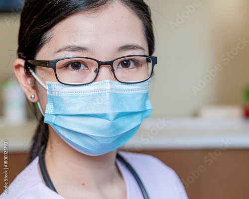 Girl health worker wearing glasses and a protective face mask