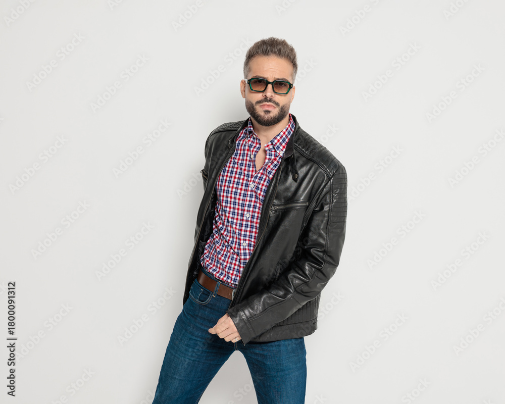 Fototapeta premium Serious bearded man posing with hand in pocket