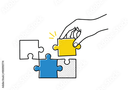 Hand completing a complex task by placing the final yellow puzzle piece into a larger strategic solution structure artwork