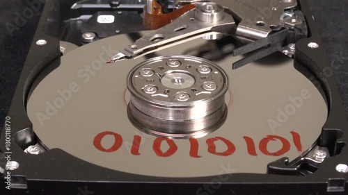 Open hard drive, close-up view, and un-write the word 01010101
