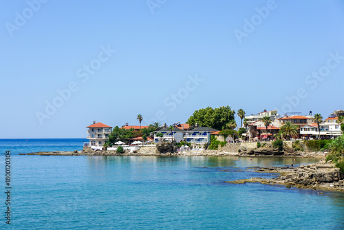 Fototapeta Naklejka Na Ścianę i Meble -  A calm blue sea with a few boats floating on it Side Antik Liman
