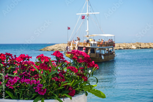 Fototapeta Naklejka Na Ścianę i Meble -  A boat is sailing in the ocean with a group of people on board
