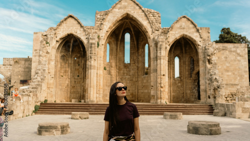 Φωτογραφία Woman exploring the sensational medieval church ruins in Rhodes, Greece