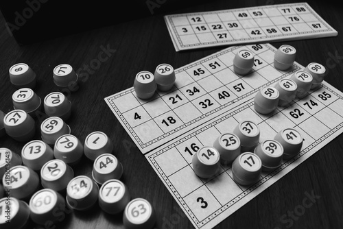 Playing lotto game, monochrome. Dices with figure on bingo card background, black and white. Nostalgia lifestyle. Table games. Retro games. Barrel with number and paper cards for bingo game.