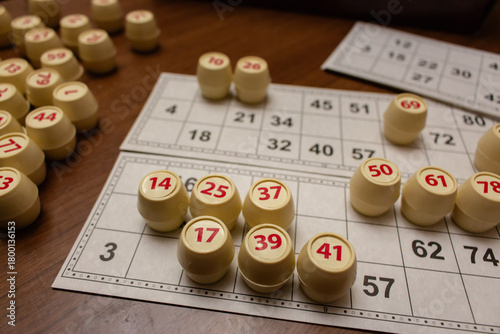 Playing lotto game. Cubes with figure on bingo card background. Nostalgia lifestyle. Table games. Retro games. Barrel with number and paper cards for bingo game. Holiday leisure. Luck concept. 