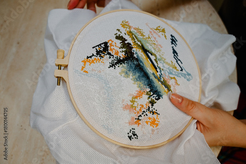 Canvastavla The process of hand embroidery with a cross on a white canvas