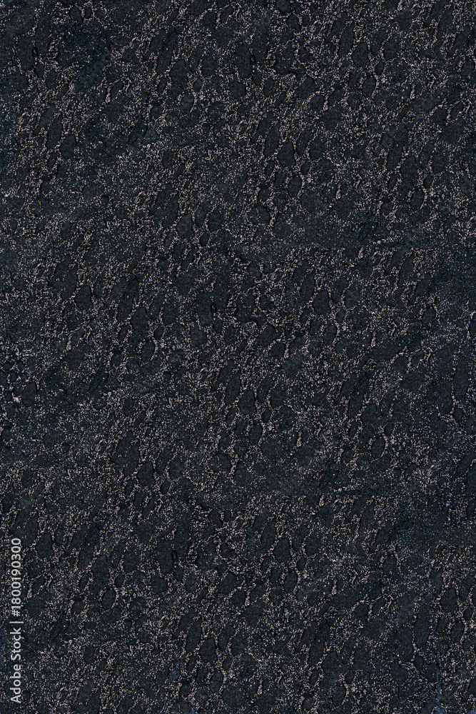 Fototapeta premium Abstract textile with spot texture: graphite lurex on a black background.