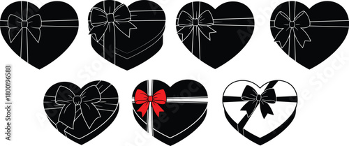 Seven heart shaped gift boxes with bows black and white with one red bow heart gift box
