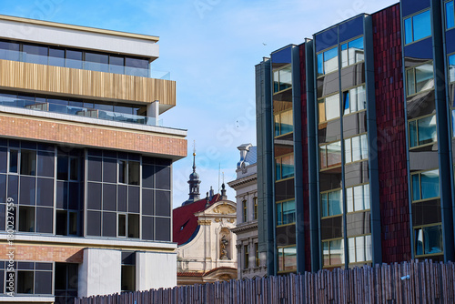 Canvas Print Modern residential and office buildings with glass facades near historic architecture in Prague