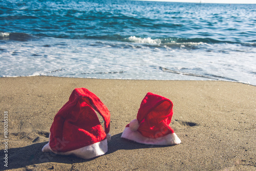 Christmas hats on sandy tropical beach