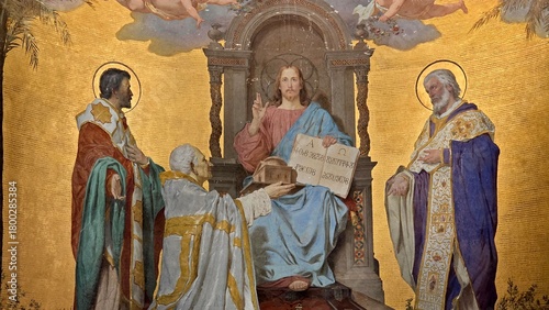 Rome, Italy - 11 January 2025. Mural from San Clemente with Christ enthroned, blessing hand raised, receiving a church model from a kneeling cleric, surrounded by saints in ceremonial robes.