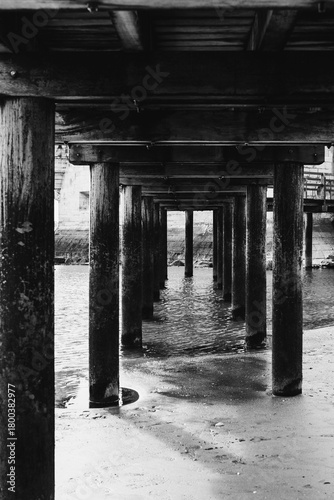 Wooden Pier Structure Over Water in Black and White