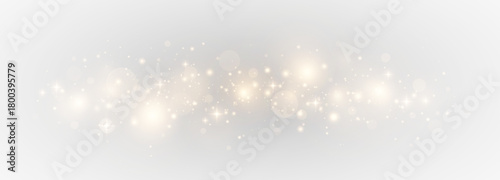 Magic luminous bokeh with sparkling particles. Festive abstract scene with glowing stardust and shimmering lights.