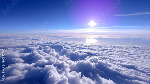 Expansive view of fluffy white clouds under a bright sun, with a clear blue sky creating a serene and tranquil atmosphere, ideal for relaxation and inspiration