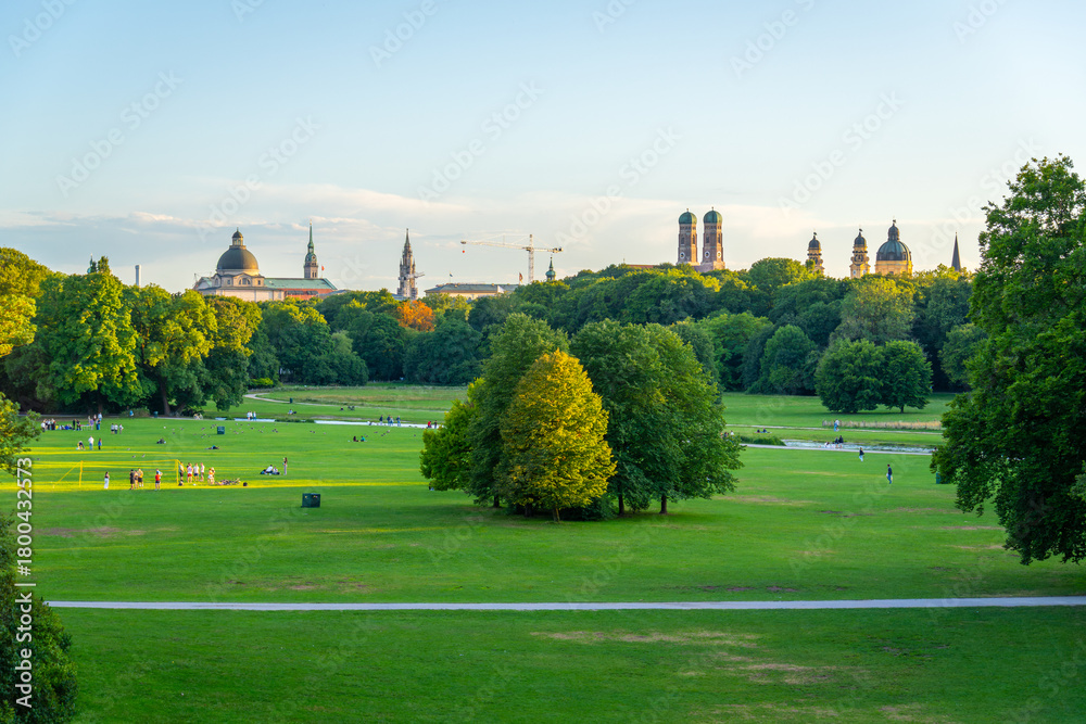 Fototapeta premium Englischer Garten Green Public Park and City Skyline on Summer Evening. Munich, Bavaria, Germany