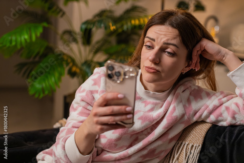 Картината върху платно Middle-aged woman at night home browses smartphone news unhappy energy low feels burnout stress