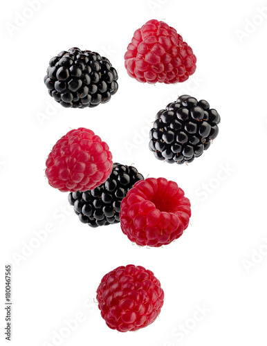 Beautifully retouched blackberries and raspberries falling through space. Isolated on white.