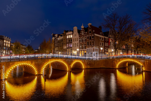 Night cityscape in the evening twilight time, Long light trail on street and canal, Architecture traditional houses, The corner of Leidsegracht and Keizersgracht, Amsterdam, Noord Holland, Netherlands