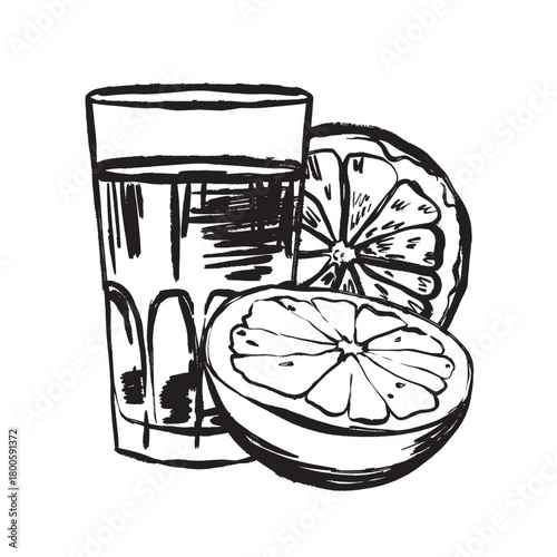 Glass of freshly squeezed citrus juice from halved fruit