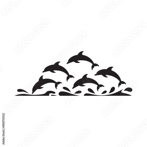 Silhouette of a pod of dolphins leaping through waves