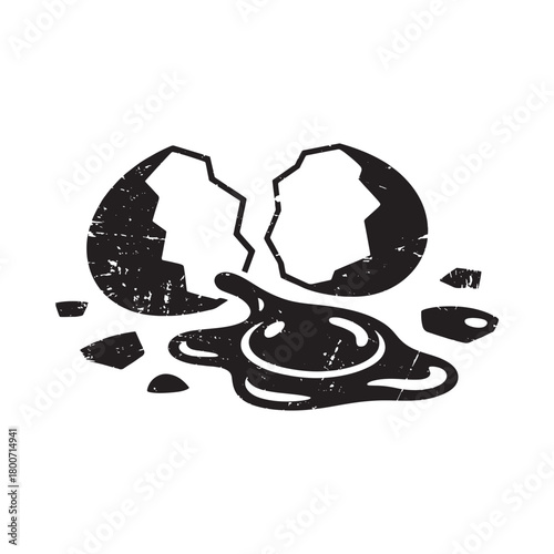 Cracked egg with spilled yolk and whites
