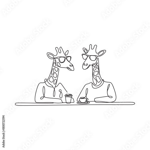 Two giraffes wearing sweaters sitting at a table
