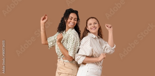 Happy young women dancing o...