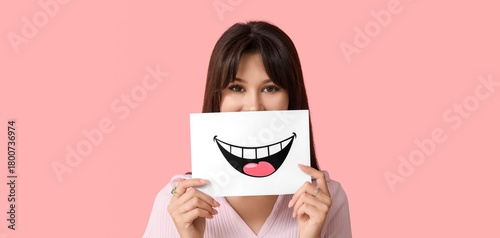 Young woman holding paper w...