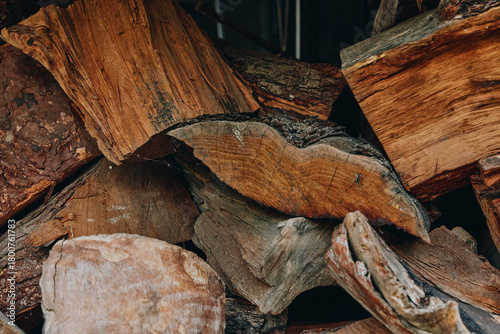 Wallpaper Mural Firewood and split logs in a stacked woodpile of seasoned hardwood and timber, kindling pieces visible with rich bark texture closeup, cozy rustic fuel supply for fireplace. Torontodigital.ca