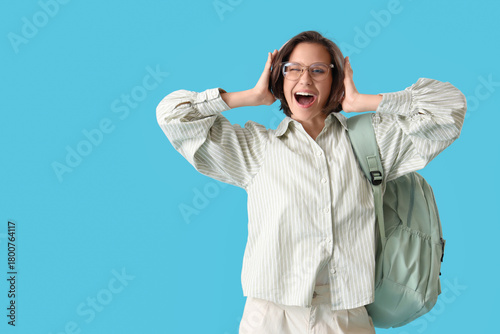 Happy female student with b...