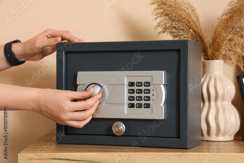 Woman opening safe on commode in office, closeup