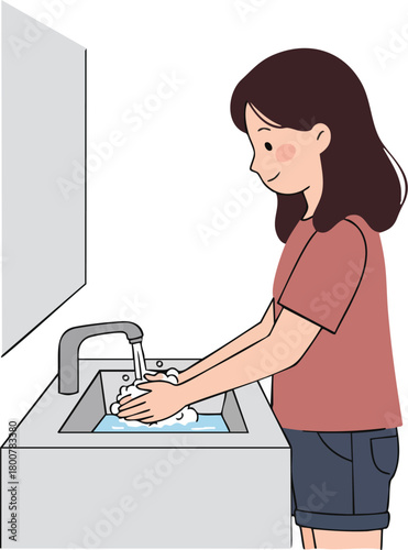 A woman washes her hands under a faucet in a sink with soap and water, standing in front of a mirror.